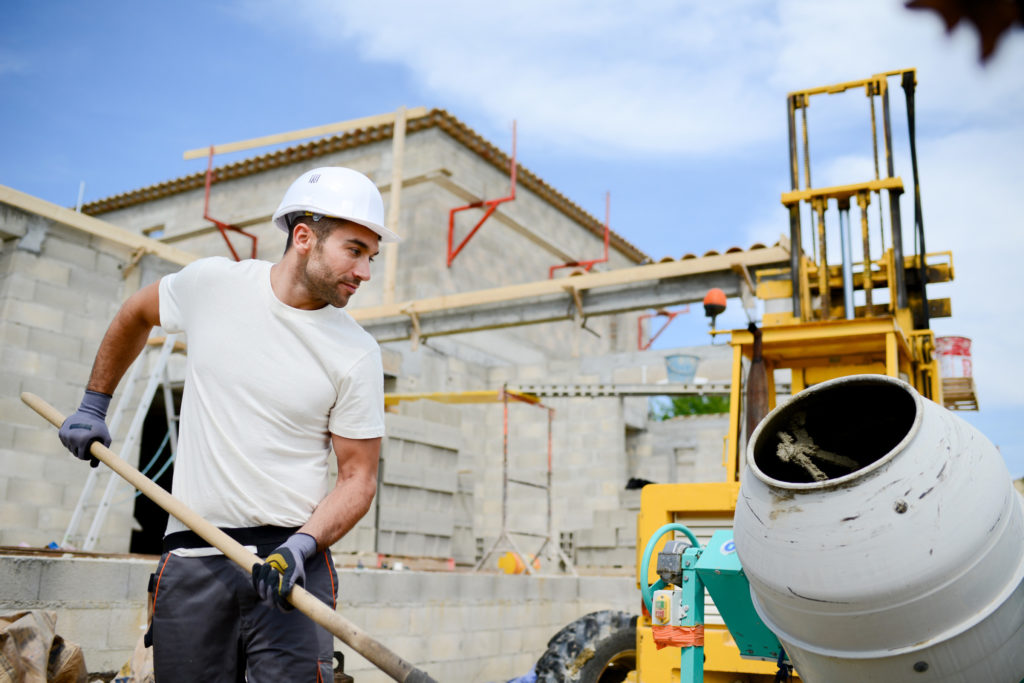 portrait of handsome construction worker on a building industry construction site