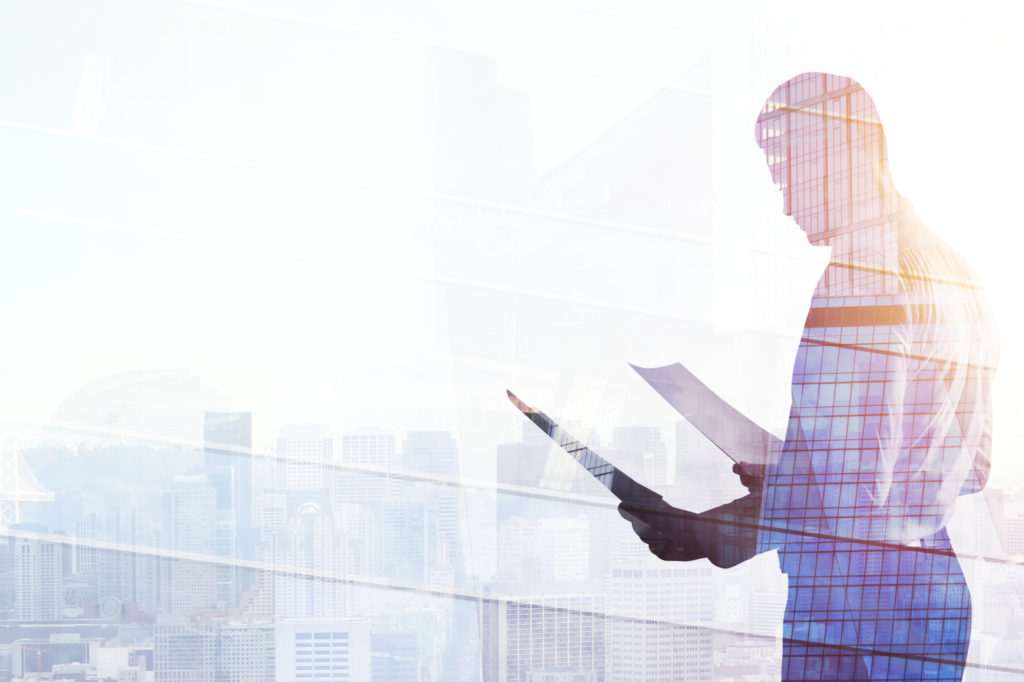 Success and employment concept. Businessman standing on abstract office city background with sunlight. Double exposure