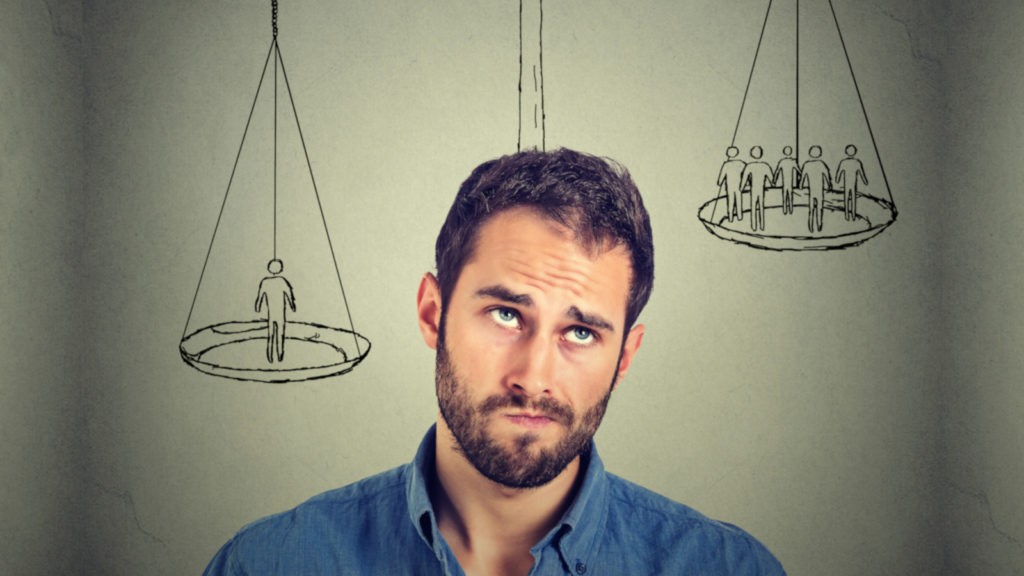 Portrait closeup funny confused skeptical man thinking looking up isolated on gray wall background with copy space above head. Human face expressions, emotions, feelings, body language