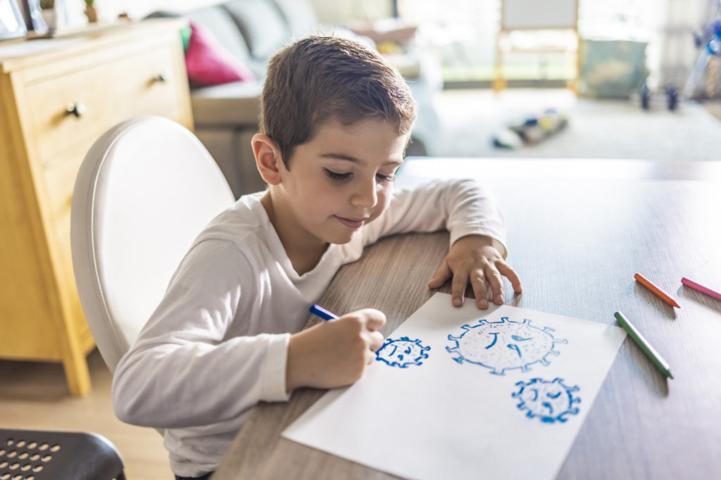Little kid drawing a coronavirus