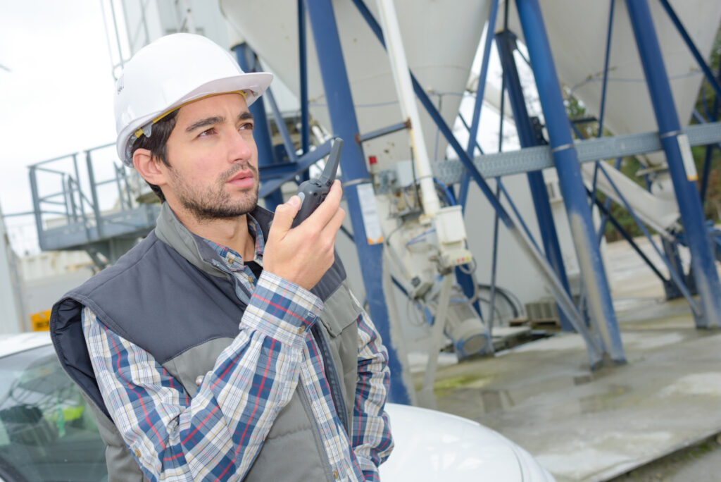 Man in cement factory using walkie talkie