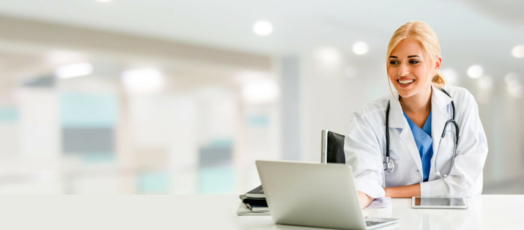 Doctor using laptop computer at the hospital. Medical healthcare and doctor staff service.