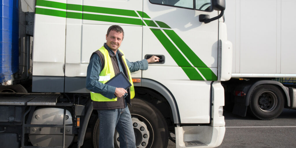 happy trucks driver in front of container delivery truck