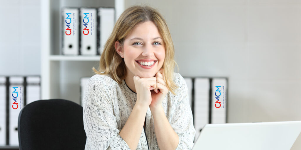 Front view portrait of a satisfied employee looking at camera at office