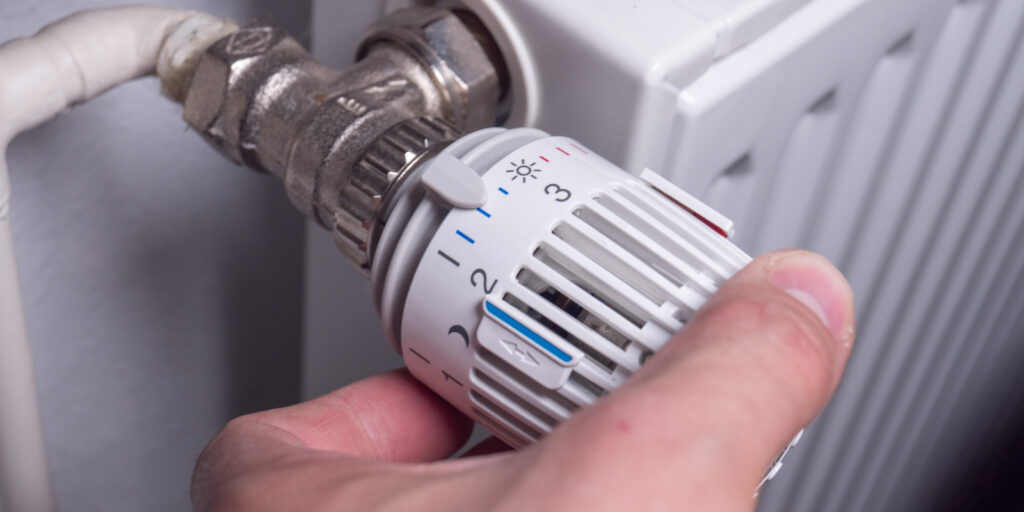 reducing temperature on thermostat to save energy, heating costs and money